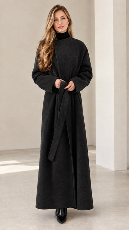 Model wearing black full-length belted wrap coat with stand collar