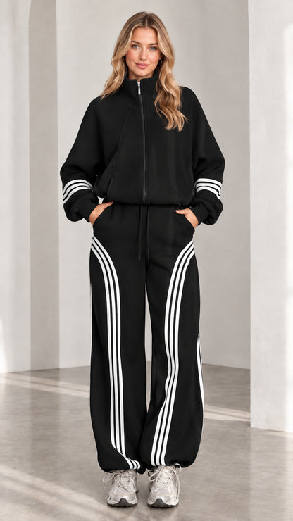 Front view of woman wearing black two-piece striped tracksuit set