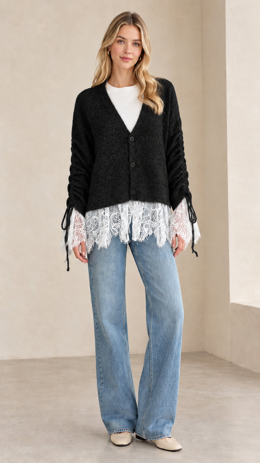 Front view of woman wearing black V-neck lace-trimmed knit cardigan
