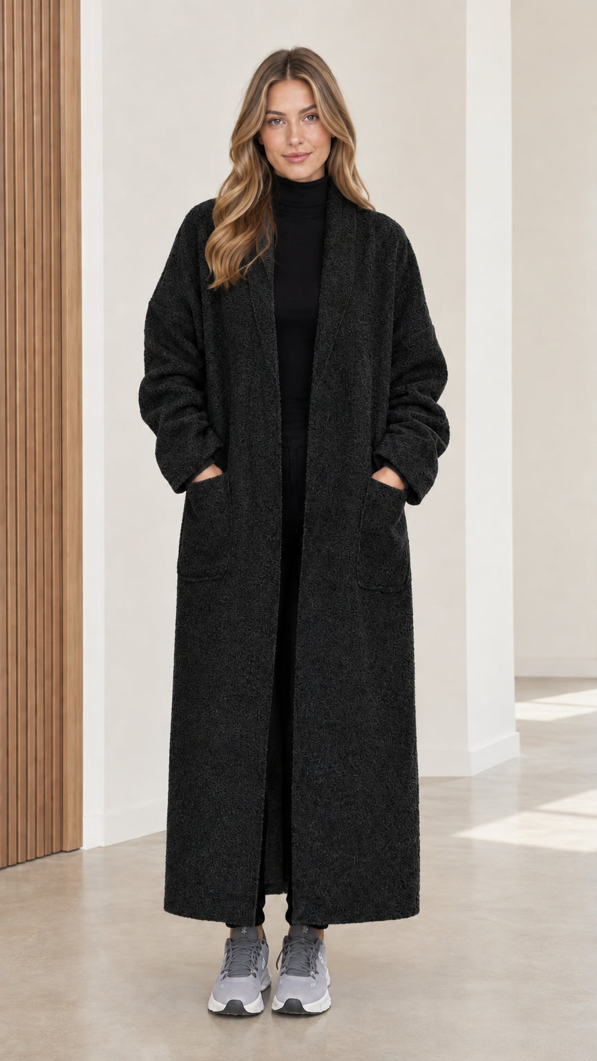 Full front view of women's black bouclé maxi coat