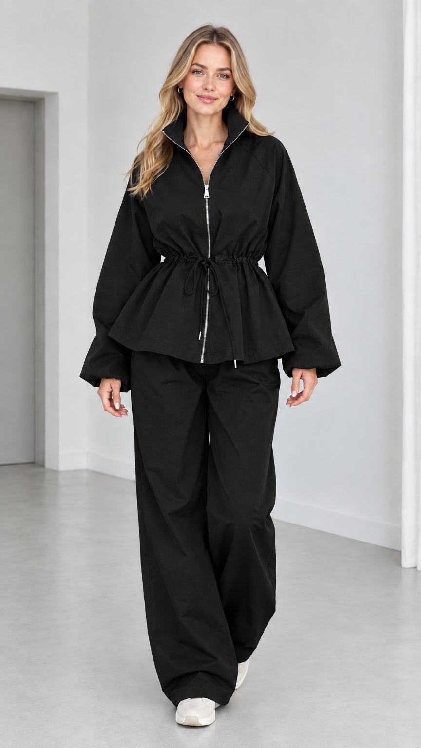 Women's black zip-up peplum jacket and matching wide-leg pants two-piece set