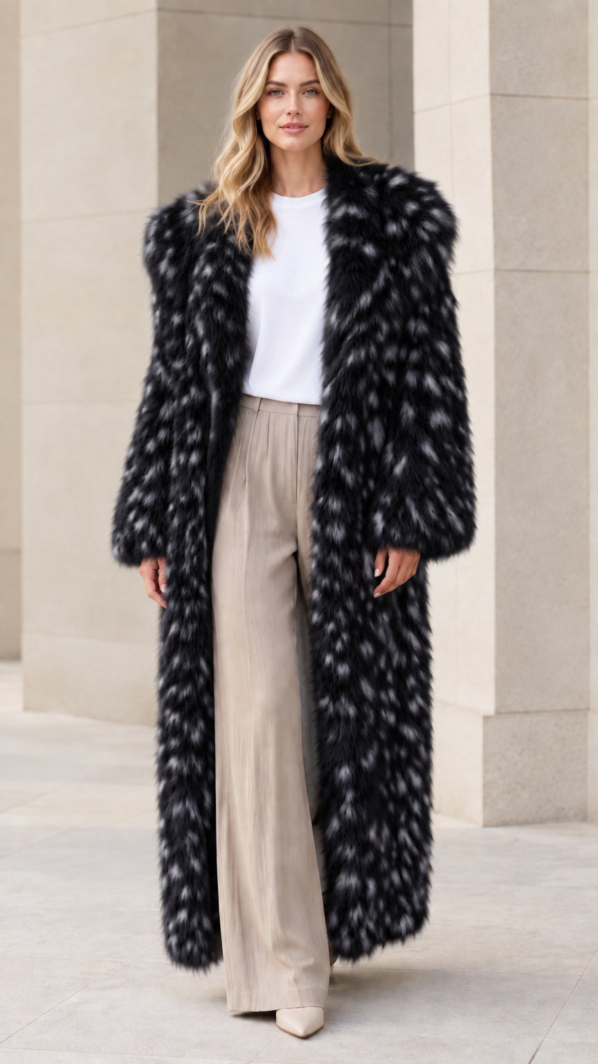 Front view of model wearing black speckled faux fur maxi coat