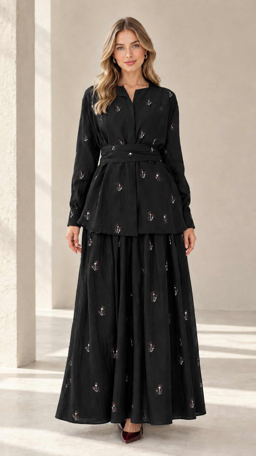 Model wearing black embroidered long sleeve tunic top and matching maxi skirt set