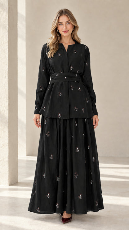 Model wearing black embroidered long sleeve tunic top and matching maxi skirt set