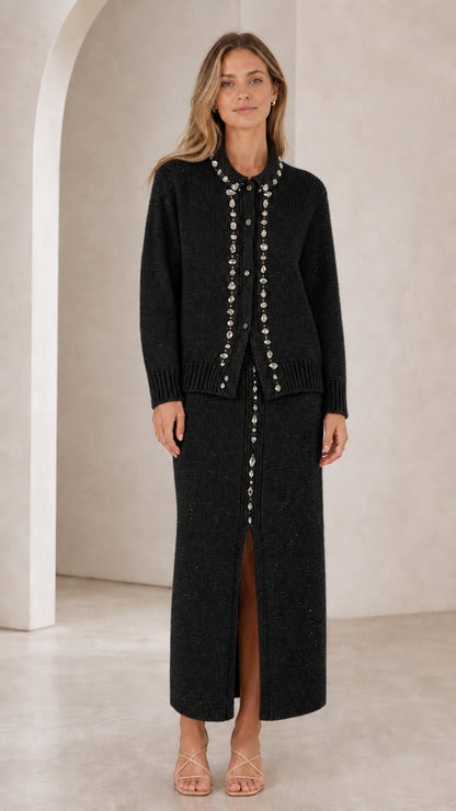 Front view of woman wearing black rhinestone-embellished knit cardigan and maxi skirt set