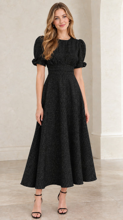 Model wearing black textured tweed puff sleeve A-line midi dress