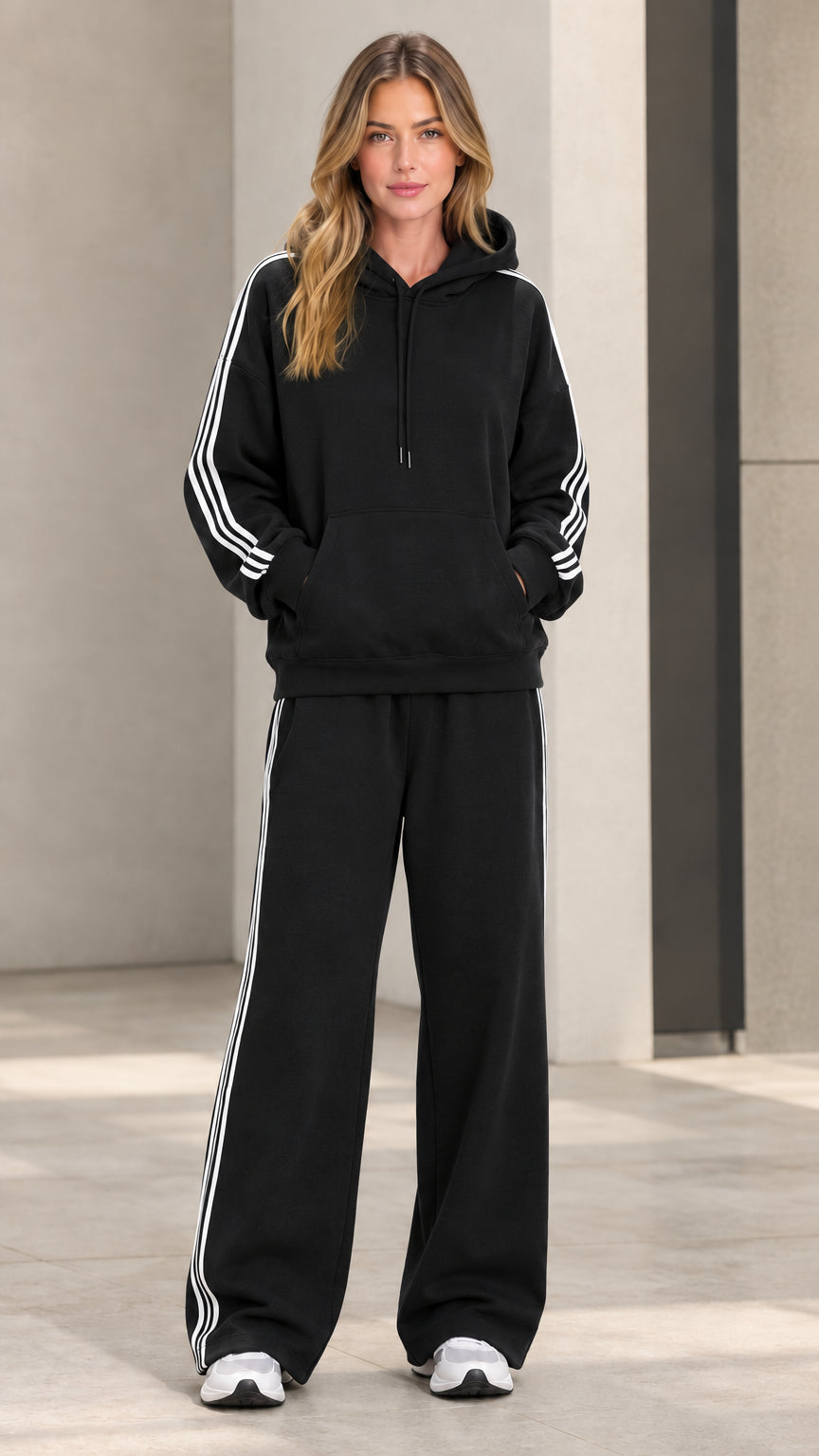 Model wearing black 2-piece striped hoodie and wide-leg sweatpants set