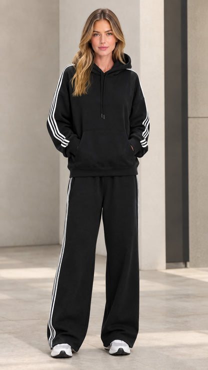 Model wearing black 2-piece striped hoodie and wide-leg sweatpants set