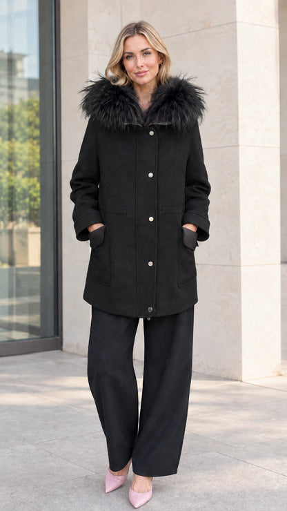 Front view of model wearing black faux fur hooded mid-length parka coat