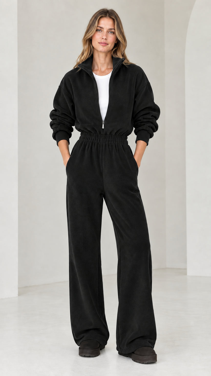 Front view of model wearing black half-zip wide leg fleece jumpsuit