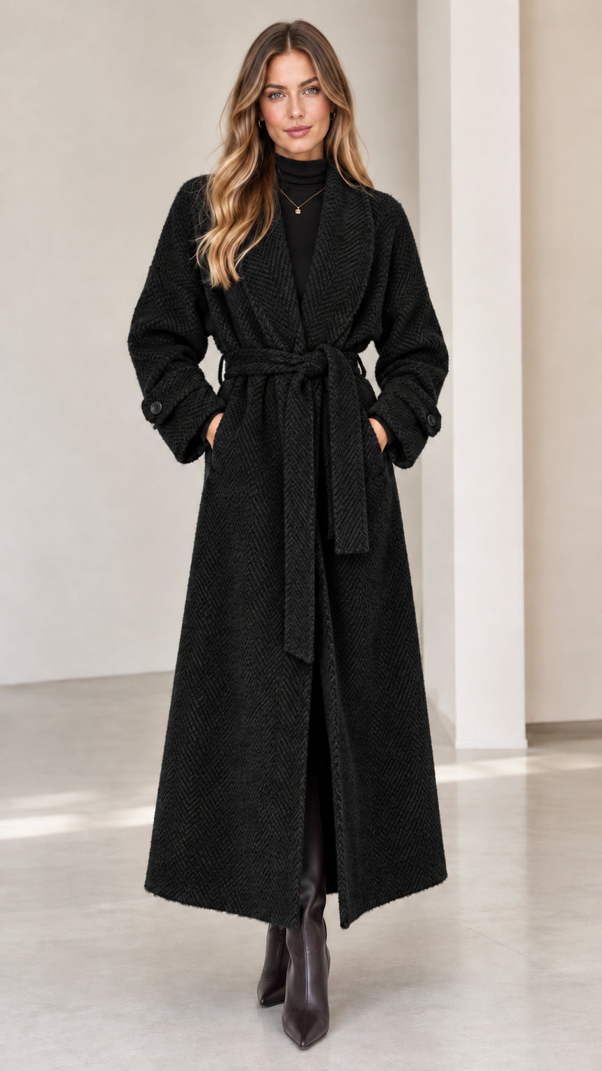 Front view of woman wearing classic black herringbone maxi wrap coat