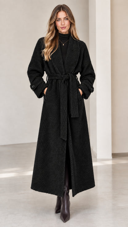 Front view of woman wearing classic black herringbone maxi wrap coat