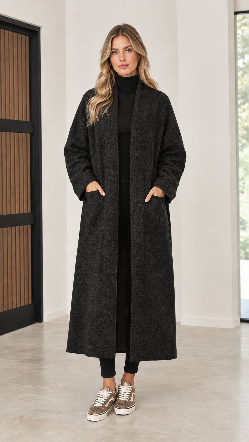 Front view of model wearing black open front maxi coatigan
