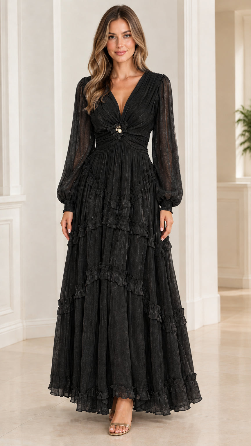 Model wearing black long-sleeve tiered plissé evening maxi dress