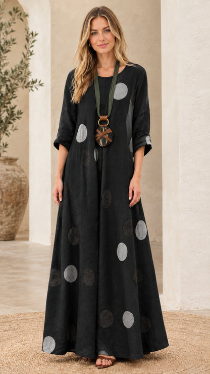 Woman wearing black polka dot relaxed fit maxi dress