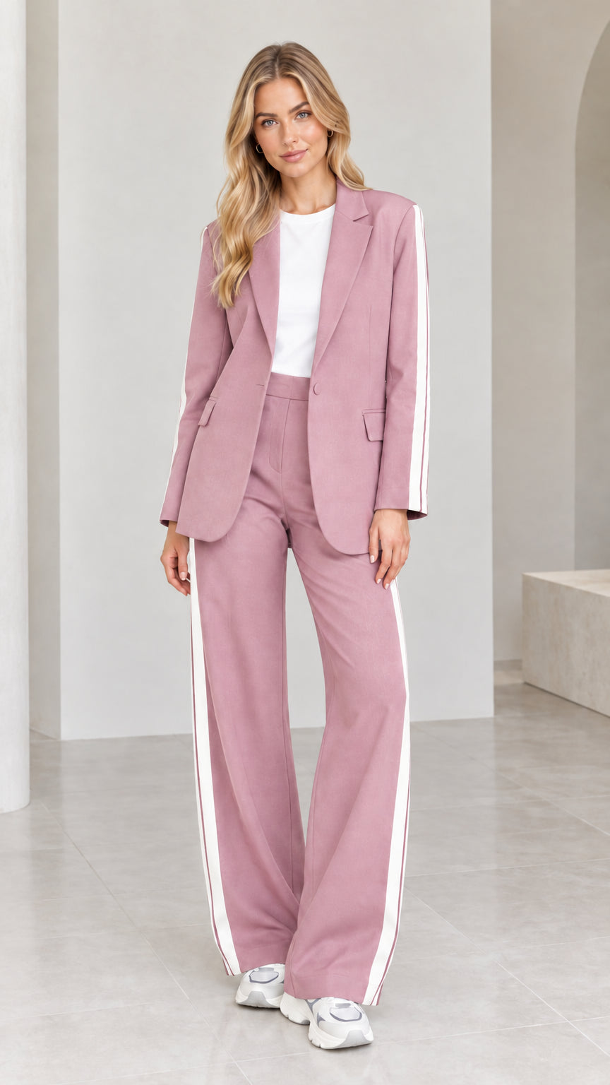 Model wearing dusty pink 2-piece blazer and wide-leg pants suit set with white side stripes