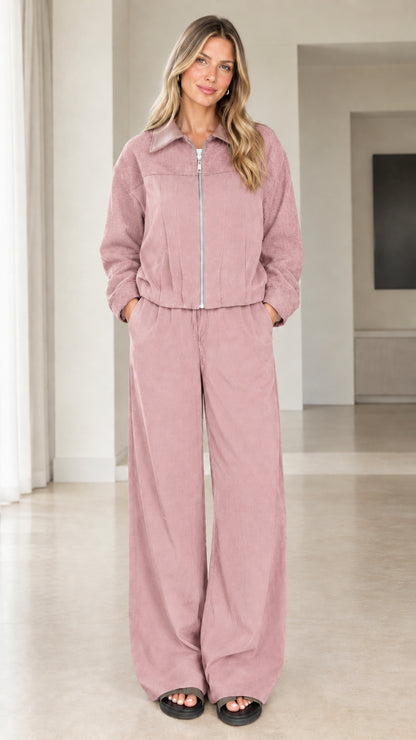 Front view of model wearing dusty pink two-piece zip jacket and pants set