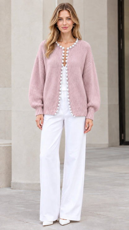 Model wearing Dusty Pink pearl-trimmed knit cardigan sweater with white trousers