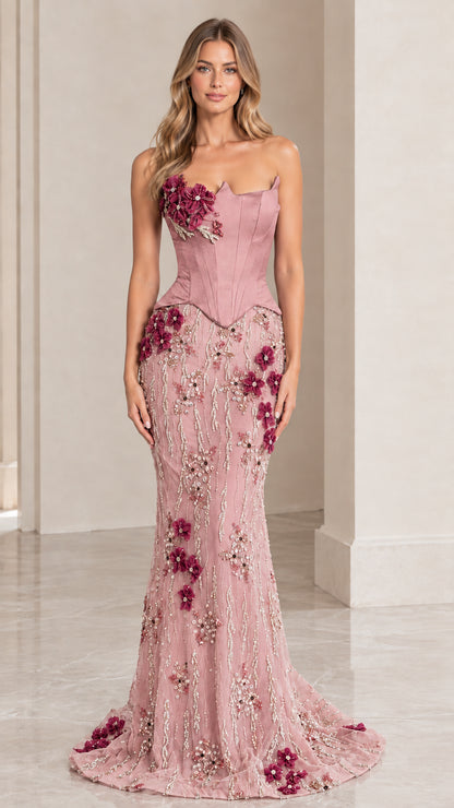 Woman wearing dusty pink strapless corset mermaid formal gown with 3D floral embroidery