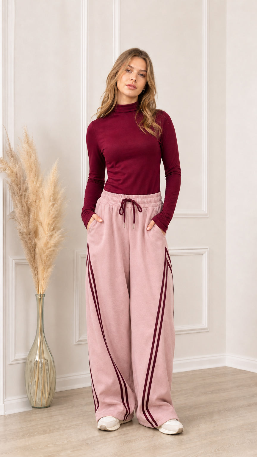 Full front view of dusty pink wide-leg sweatpants with burgundy side stripes