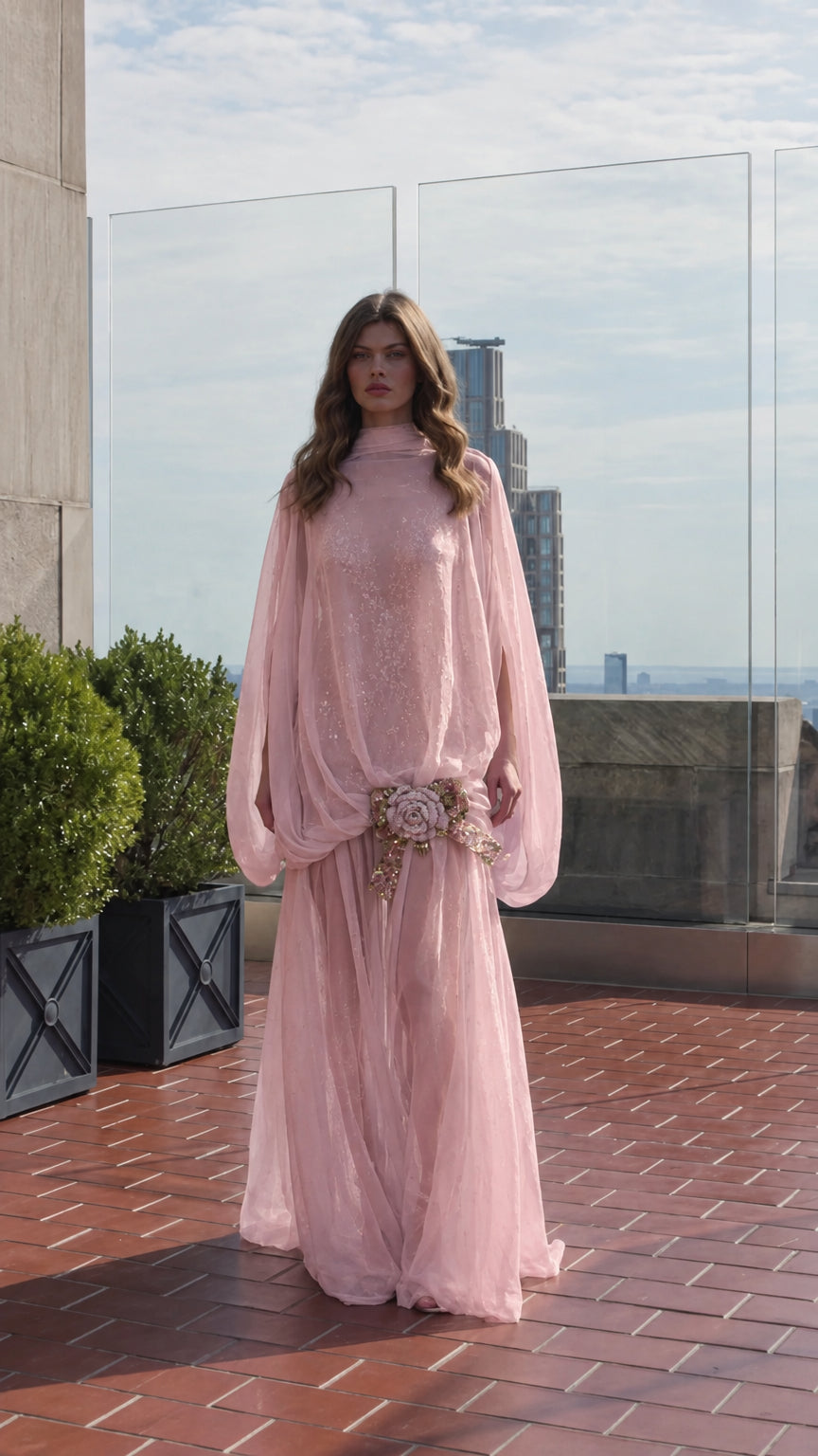 Model wearing blush pink cape sleeve formal maxi dress with sequin details
