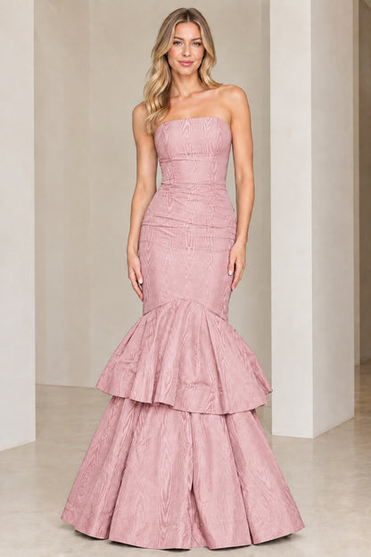 Model wearing dusty pink strapless tiered mermaid evening gown