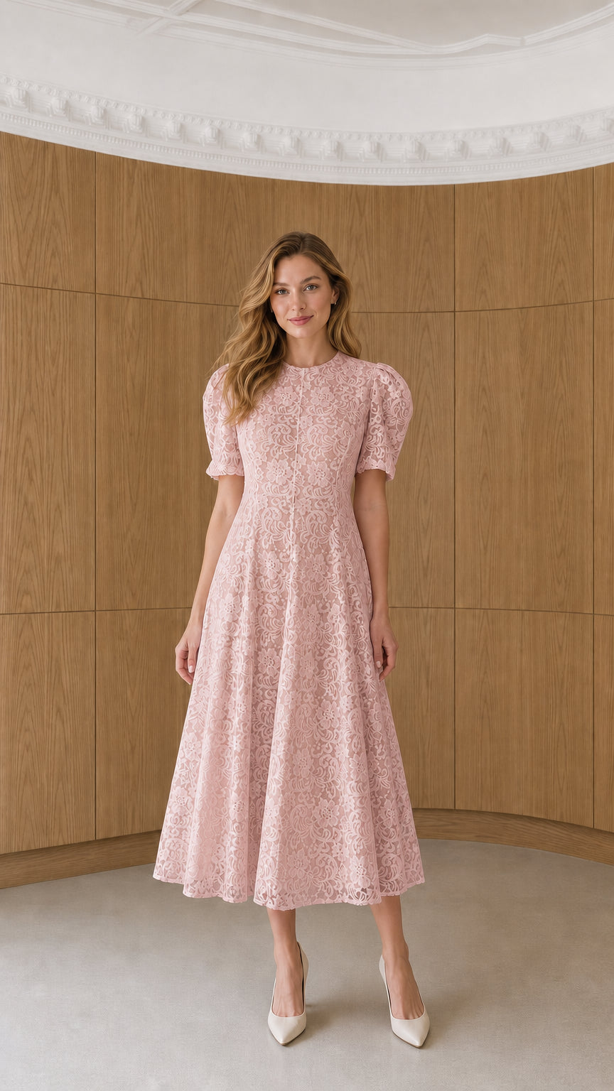 Full-length view of model wearing blush pink floral lace puff sleeve midi dress
