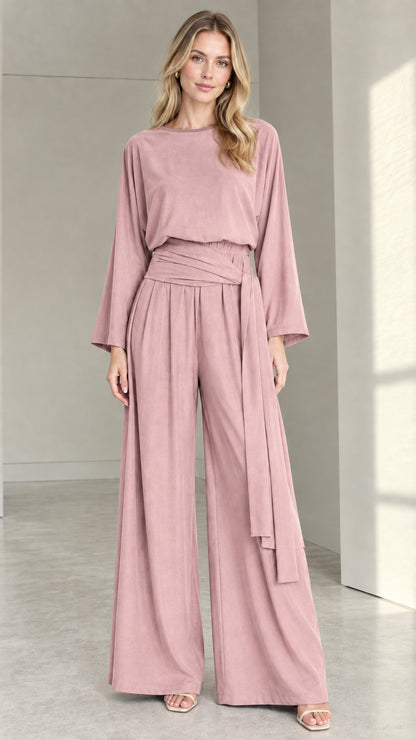 Front full view of woman wearing dusty rose pink long-sleeve wide-leg jumpsuit