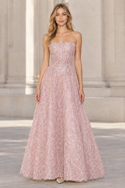 Front view of model wearing blush pink strapless embellished A-line evening gown