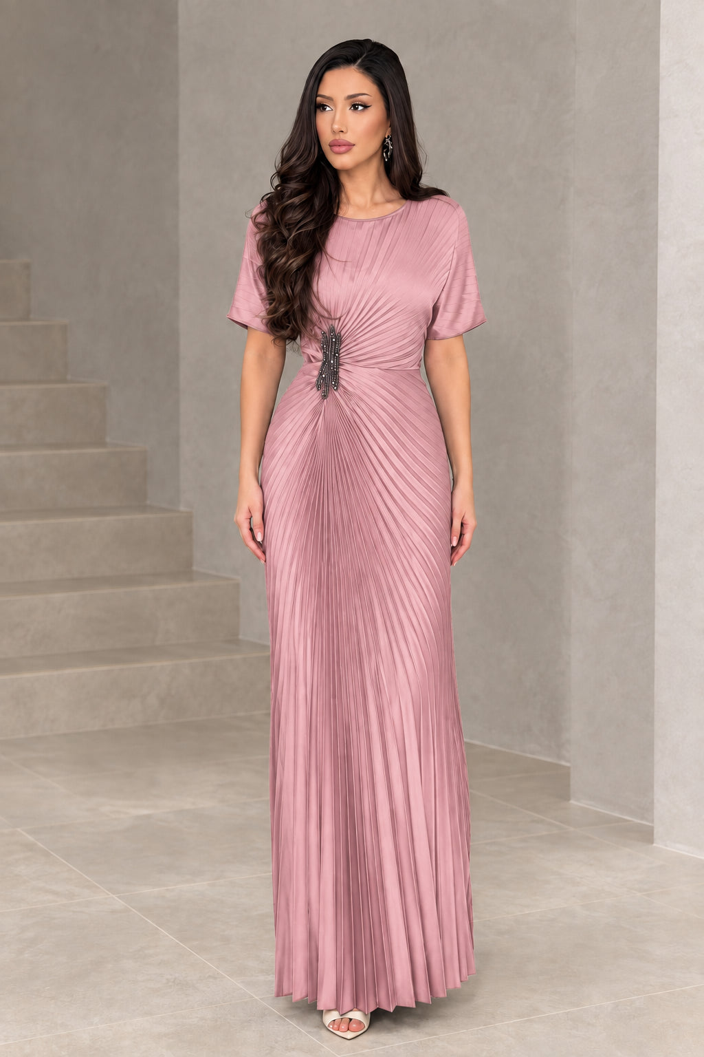 Front full-length view of woman wearing dusty pink pleated evening gown