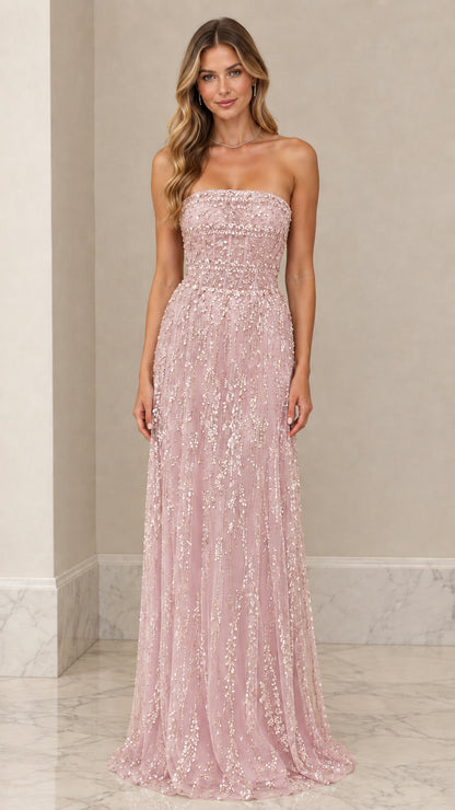 Front view of model wearing Blush Pink strapless beaded corset formal gown