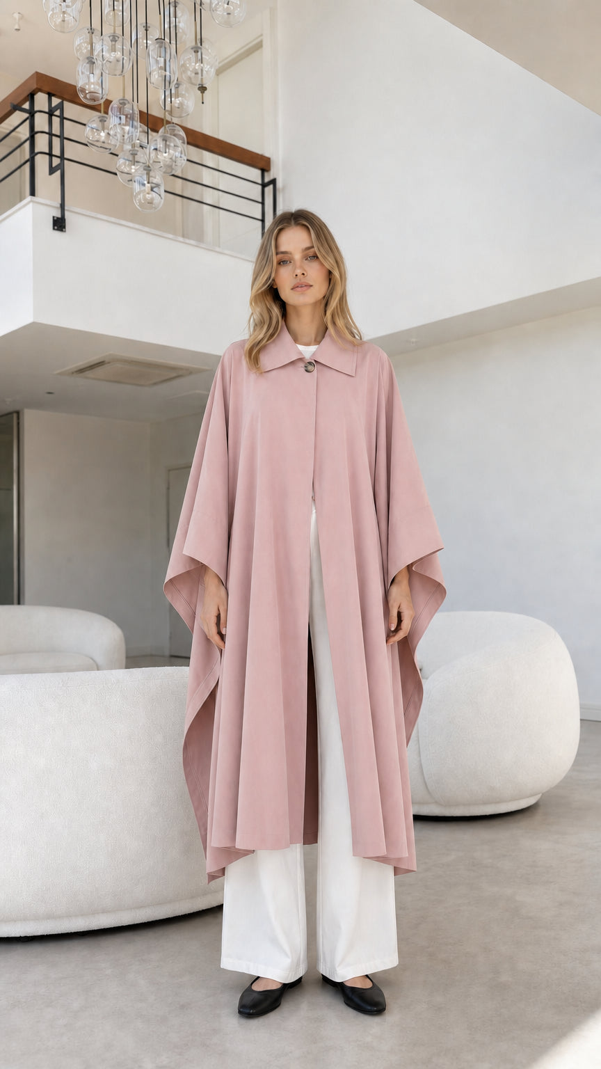 Full front view of model wearing dusty pink flowing cape coat