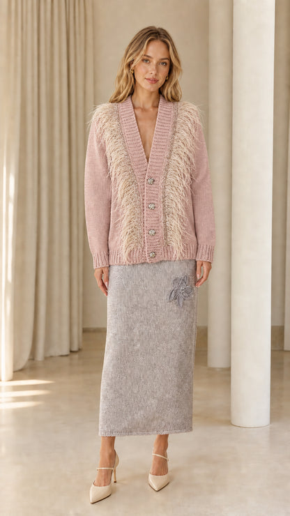 Front view of woman wearing dusty pink feather trim cardigan sweater