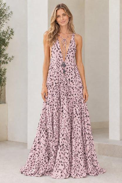 Model wearing light pink dotted print sleeveless tiered maxi dress