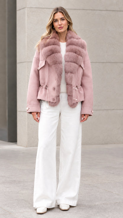 Woman wearing dusty pink faux fur trim short jacket with white wide-leg trousers