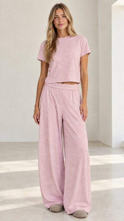 Model wearing heather pink short sleeve crop tee and wide leg pants loungewear set