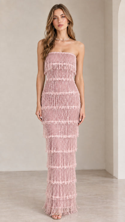 Front view of model wearing dusty pink strapless tiered fringe maxi dress