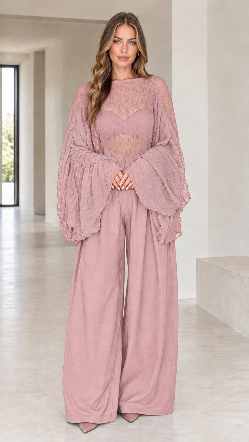 Front view of woman wearing dusty pink sheer pleated bell sleeve top and wide-leg pants set