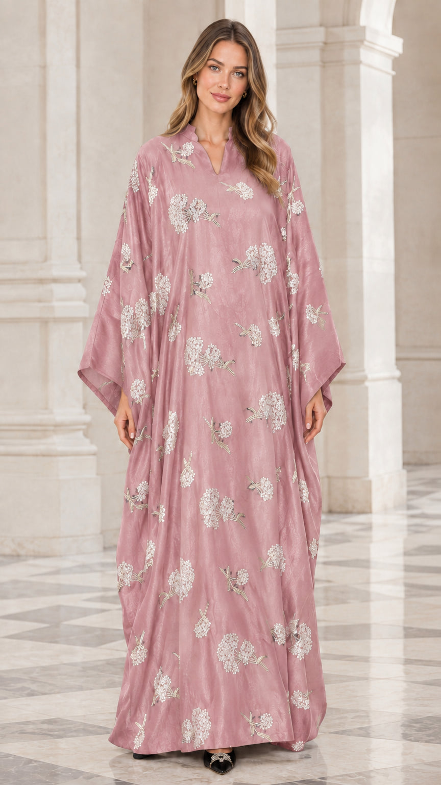 Front view of woman wearing dusty pink floral embroidered kaftan maxi dress