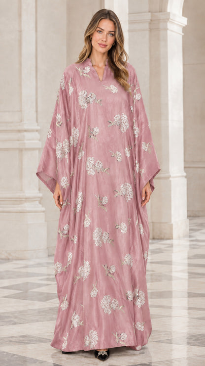 Front view of woman wearing dusty pink floral embroidered kaftan maxi dress