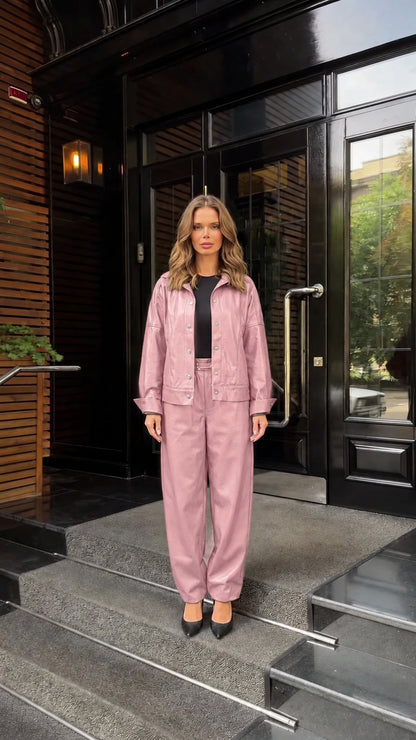 Front view of woman wearing dusty pink faux leather jacket and pants set