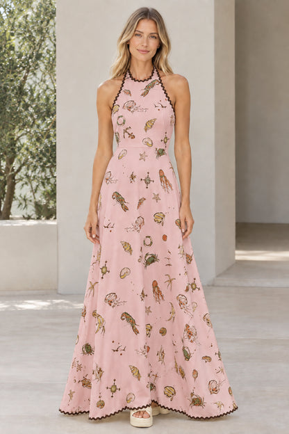 Model wearing blush pink marine print halter maxi dress