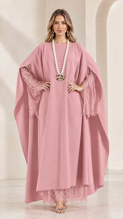 Front view of woman wearing blush pink lace-trimmed cape kaftan dress