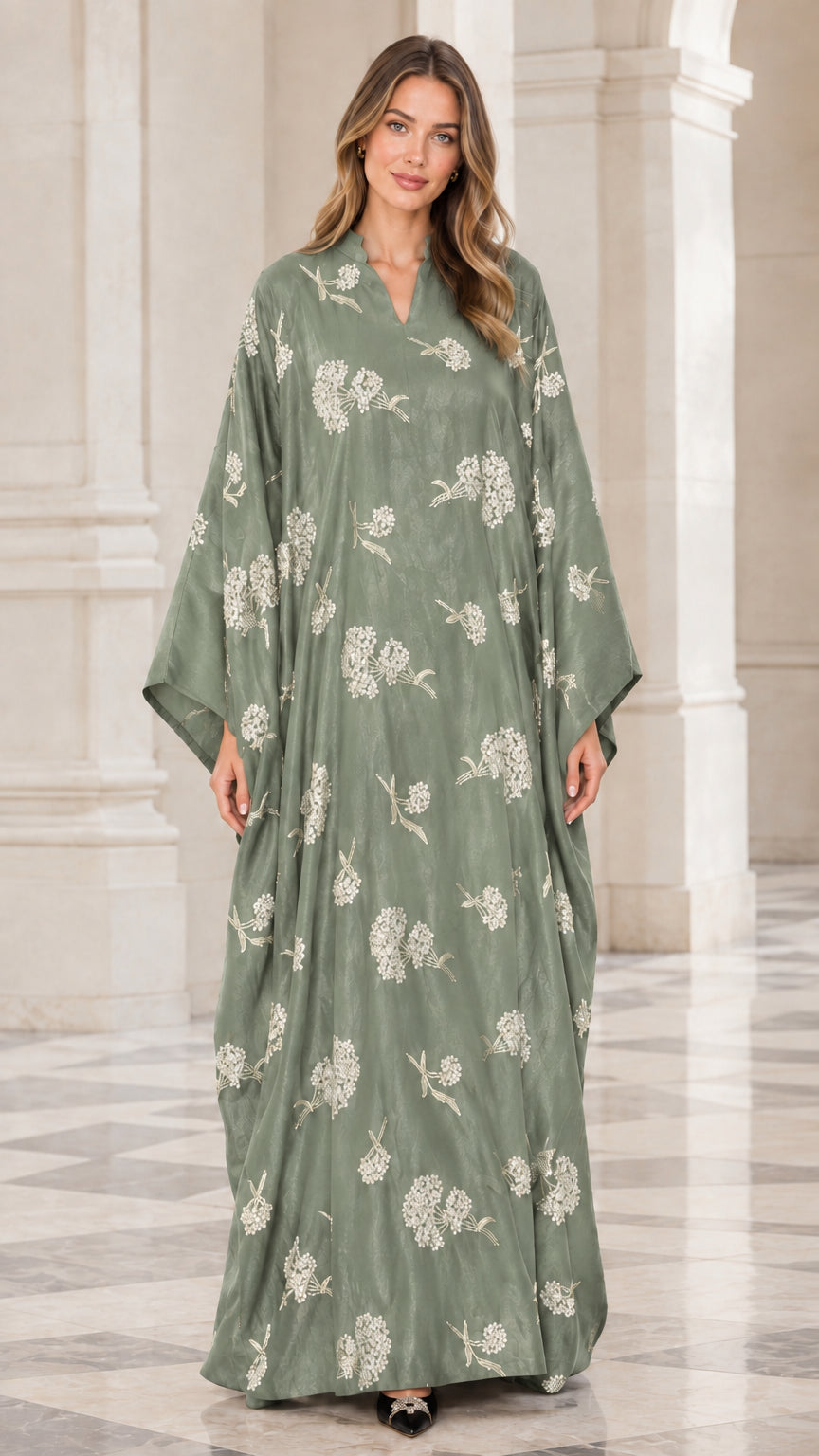 Front view of woman wearing sage green floral embroidered kaftan maxi dress