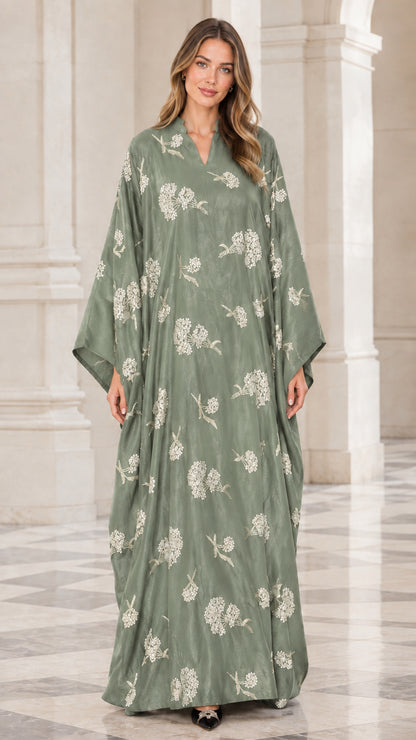 Front view of woman wearing sage green floral embroidered kaftan maxi dress