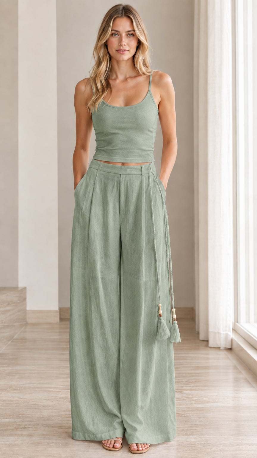 Front view of model wearing sage green two-piece cami and flowy trousers set