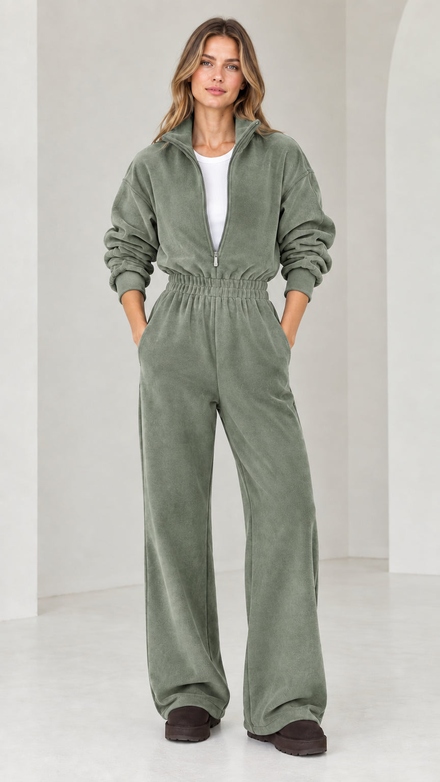 Front view of model wearing sage green half-zip wide leg fleece jumpsuit