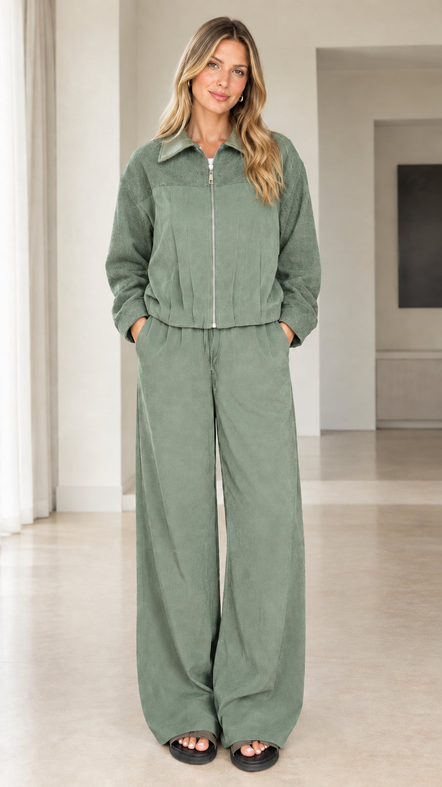 Front view of model wearing sage green two-piece zip jacket and pants set