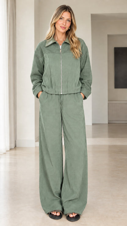 Front view of model wearing sage green two-piece zip jacket and pants set