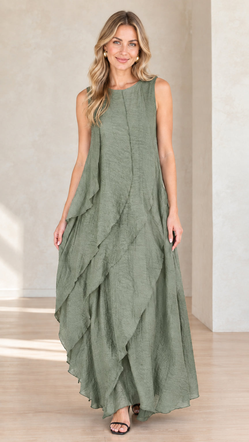 Model wearing sage green sleeveless tiered flowy maxi dress
